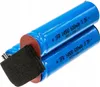 Two blue batteries are shown in a close-up shot, with a black foam piece in the foreground. Produktbild-Vorschau