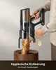 A person is emptying a cordless vacuum cleaner into a wooden bin. Produktbild-Vorschau
