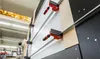 A person is using a vertical panel saw with clamps to cut a wooden panel. Náhľad obrázku produktu