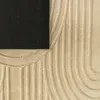 A close-up view of a rug, showing its texture and geometric pattern. The black backing of the rug is visible in the top-left corner. Produktbild-Vorschau