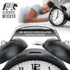 A man sleeping in bed next to an alarm clock. Anteprima dell’immagine prodotto