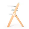 A side view of a wooden high chair with a tray and straps. Náhľad obrázku produktu