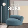 A modern living room scene featuring a large, round, aquamarine beanbag sofa, a floor lamp, and teal curtains. Náhľad obrázku produktu