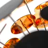 A close-up view of a modern chandelier with multiple golden discs. Podgląd zdjęcia produktu