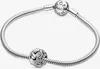 A silver Pandora bracelet with two charms, one of which is a detailed seashell charm. Anteprima dell’immagine prodotto