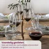 A table setting with wine glasses and a decanter filled with red wine. Náhľad obrázku produktu