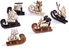A collection of wooden Christmas tree ornaments shaped like sleds with various festive figures. Náhľad obrázku produktu
