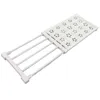 A white, adjustable shelf unit with metal rods and a decorative plastic top, shown against a white background. Anteprima dell’immagine prodotto