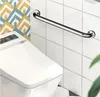 A grab bar is mounted on a tiled wall next to a toilet. Anteprima dell’immagine prodotto