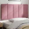 A pink upholstered headboard is mounted on a wall above a bed with white and gray bedding. Produktbild-Vorschau
