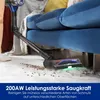 A person is using a cordless vacuum cleaner to clean a rug in a living room, with a blue sofa in the background. Produktbild-Vorschau