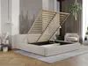 A bedroom scene featuring a beige upholstered bed with its storage compartment open, revealing the slatted base. A chair and a hanging plant are visible in the background. Produktbild-Vorschau