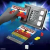 A Monopoly electronic banking game set with cards and a reader, along with game tokens, presented against a digital blue and black background. Náhľad obrázku produktu
