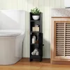 A narrow black cabinet is placed next to a toilet and a wooden vanity in a bathroom. Podgląd zdjęcia produktu