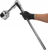 A gloved hand holds a large socket wrench with a socket attached. Produktbild-Vorschau
