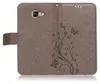 A brown flip case for a Samsung Galaxy A5 2016 with a floral and butterfly embossed design. Produktbild-Vorschau