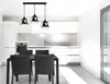 A modern kitchen with a dining table and chairs, illuminated by a pendant light fixture. Náhled obrázku produktu
