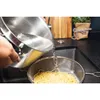 Water being poured from a pot into a colander with spaghetti. Voir les images du produit