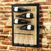 A wine rack mounted on a brick wall, holding wine bottles and wine glasses. Produktbild-Vorschau