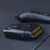Two black electric shavers are placed on a dark surface. Anteprima dell’immagine prodotto