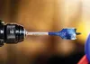 A close-up shot of a drill bit attached to a drill. Anteprima dell’immagine prodotto
