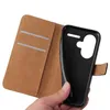 A hand holds a black phone case, revealing the inside of a brown flip cover case with card slots. Produktbild-Vorschau