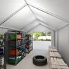 Interior of a storage tent with shelves filled with various storage containers and a tire on the floor. Produktbild-Vorschau