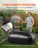 A man is watering a large black water storage bladder in a backyard setting. Náhled obrázku produktu