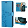 Collage of a blue flip phone case with floral embossing, showing the case closed, open with cards inserted, and the phone inside. Produktbild-Vorschau