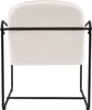 The back view of a beige upholstered armchair with a black metal frame. Náhled obrázku produktu