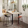 A dining area with a bar table and stools, set near a window with plants. Produktbild-Vorschau