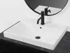 A white rectangular sink with a black faucet is shown on a dark marble countertop, with a round black mirror reflecting the faucet and sink in the background. Podgląd zdjęcia produktu