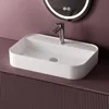 A white ceramic sink with a chrome faucet is shown on a purple vanity with a ribbed texture. A circular mirror with LED lighting is visible in the background. Voir les images du produit
