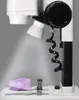 A close-up view of a microscope with a purple sample on a stage. Anteprima dell’immagine prodotto