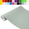A roll of light green matte self-adhesive film or wallpaper, displayed diagonally on a white background. Produktbild-Vorschau