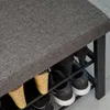 A close-up view of a shoe bench with shoes on its shelves. Podgląd zdjęcia produktu