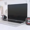 A laptop and two small speakers on a desk. Produktbild-Vorschau
