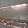 A close-up view of a kitchen sink area with under-cabinet lighting. Produktbild-Vorschau