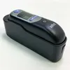 A black Braun ear thermometer rests in its black charging/storage base, set against a white background. Produktbild-Vorschau