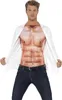 A man wearing a shirt that appears to have a muscular chest printed on it, and dark blue jeans. Produktbild-Vorschau