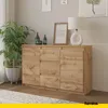 A modern sideboard with drawers and doors is placed in a living room setting, next to a potted plant and a table lamp. Anteprima dell’immagine prodotto