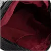 Close-up view of the inside of a black bag with a red lining. Produktbild-Vorschau
