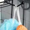 Close-up of a shower caddy with bath accessories hanging from it. Anteprima dell’immagine prodotto