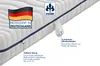 A close-up view of a mattress with informational text and logos. Produktbild-Vorschau