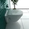 A modern bathroom setting with a wall-mounted toilet and green tiled wall. Produktbild-Vorschau