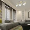A modern living room with a large sectional sofa, blinds on the windows, and a gold track light fixture on the ceiling. Produktbild-Vorschau