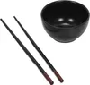 A black bowl and two black chopsticks are arranged on a white background. Náhled obrázku produktu