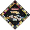 A diamond-shaped Monopoly board with a black background, featuring gold accents and various images of luxury items and locations. Produktbild-Vorschau
