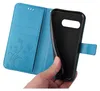 A hand is holding a blue flip phone case open, revealing the inside of the case and the phone it is designed to hold. Produktbild-Vorschau