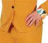 A close-up of a person's torso wearing a yellow suit with a patterned cuff. Produktbild-Vorschau